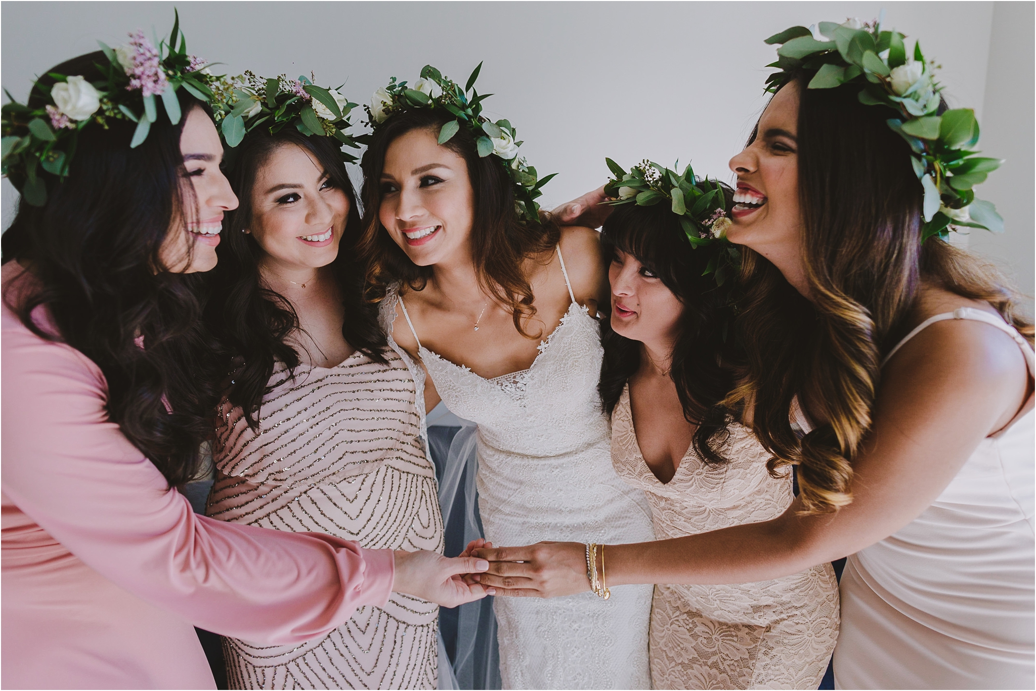 bridal party laughing and hugging