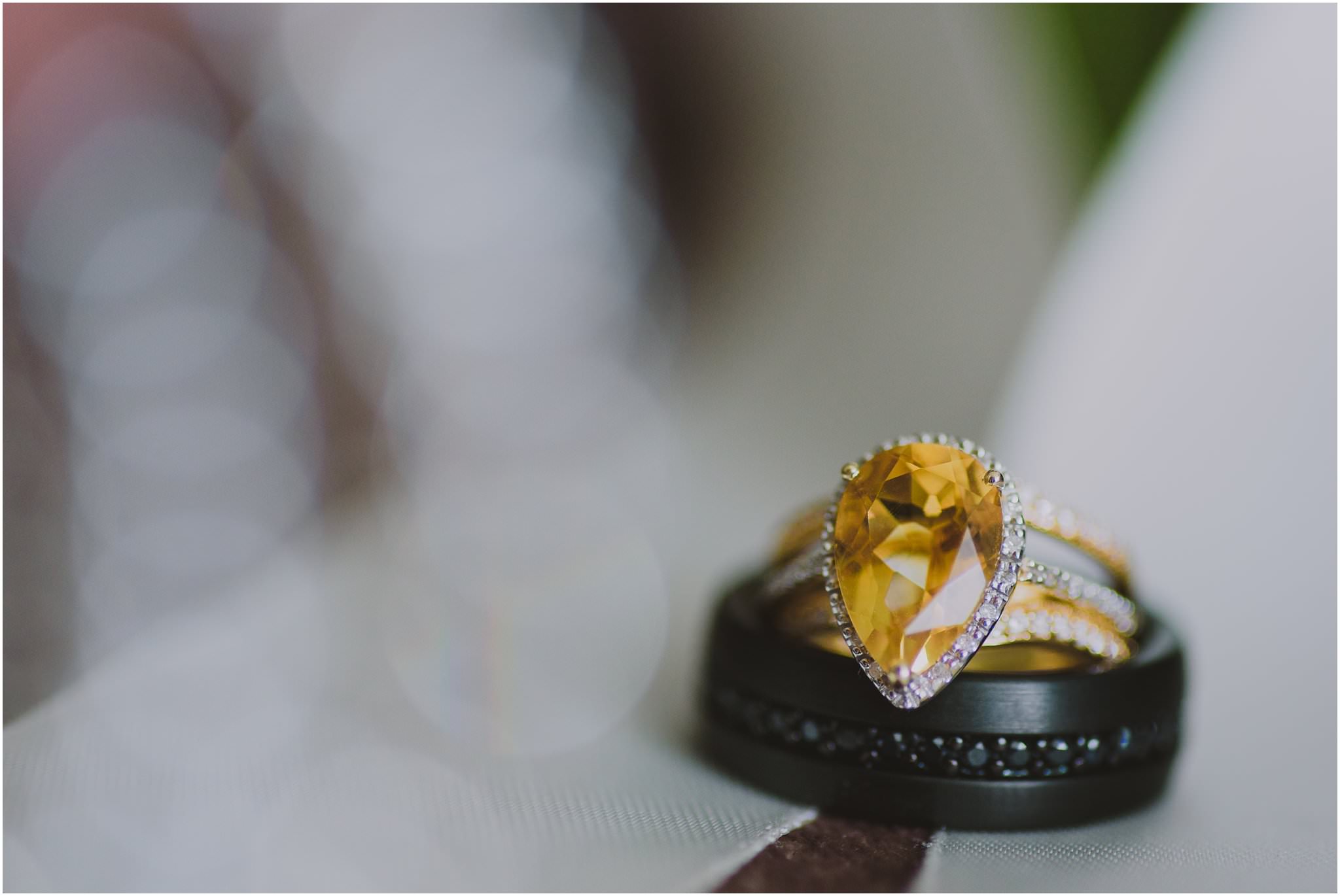 canary yellow pear cut diamond engagement ring and black band