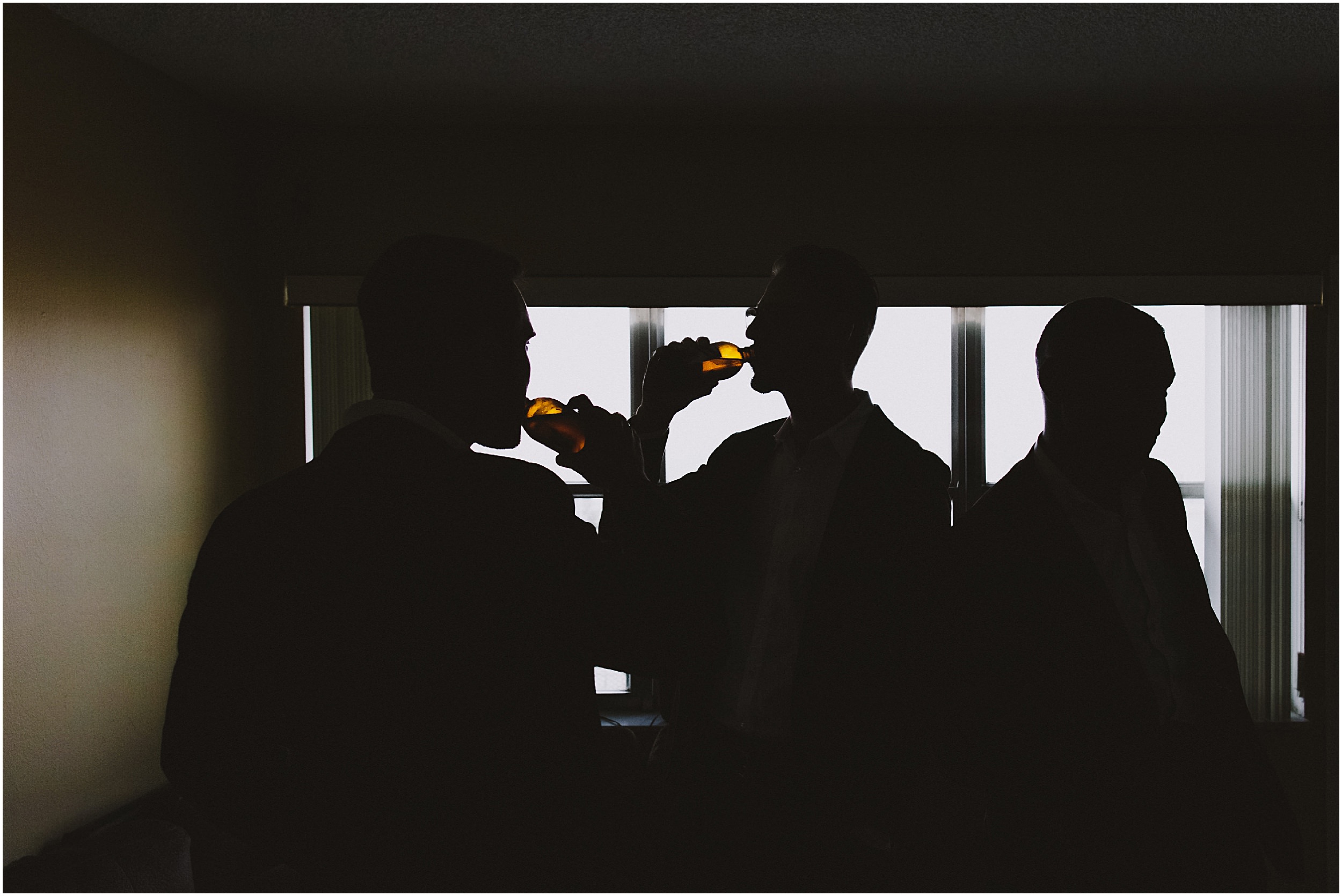 silhouette of groomsmen drinking beer