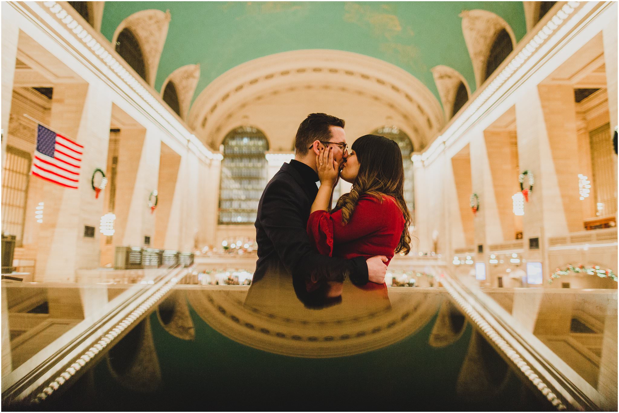 reflection shot in Grand Central Station with couple kissing in the middle