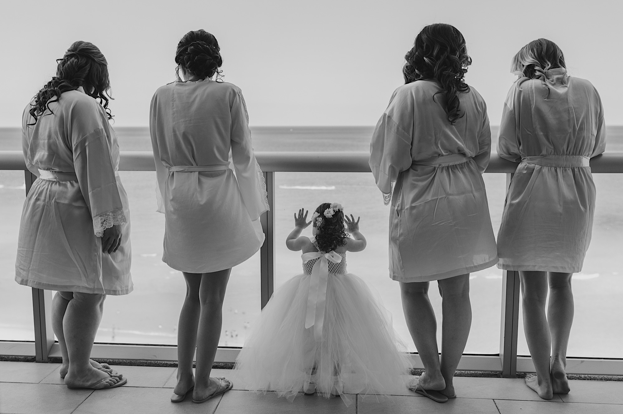 bridesmaids looking out of the hotel balcony