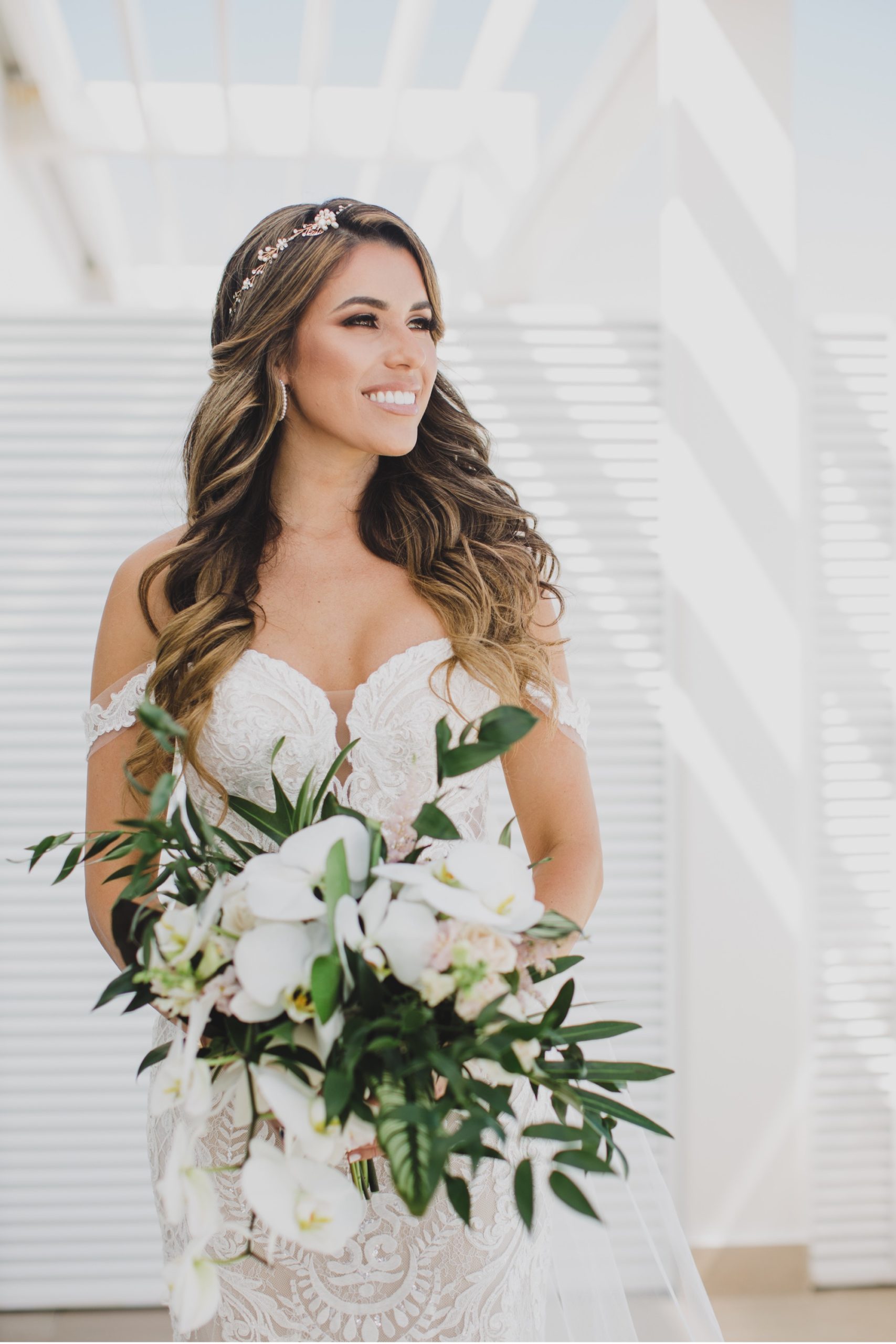Beautiful bride with large white orchid bouquet