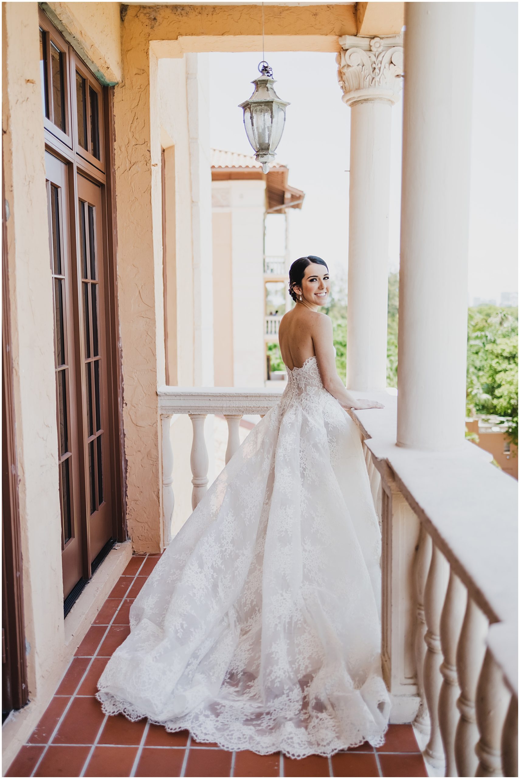 Bride overlooking the golf course from her balcony at the Biltmore Hotel in Coral gables.