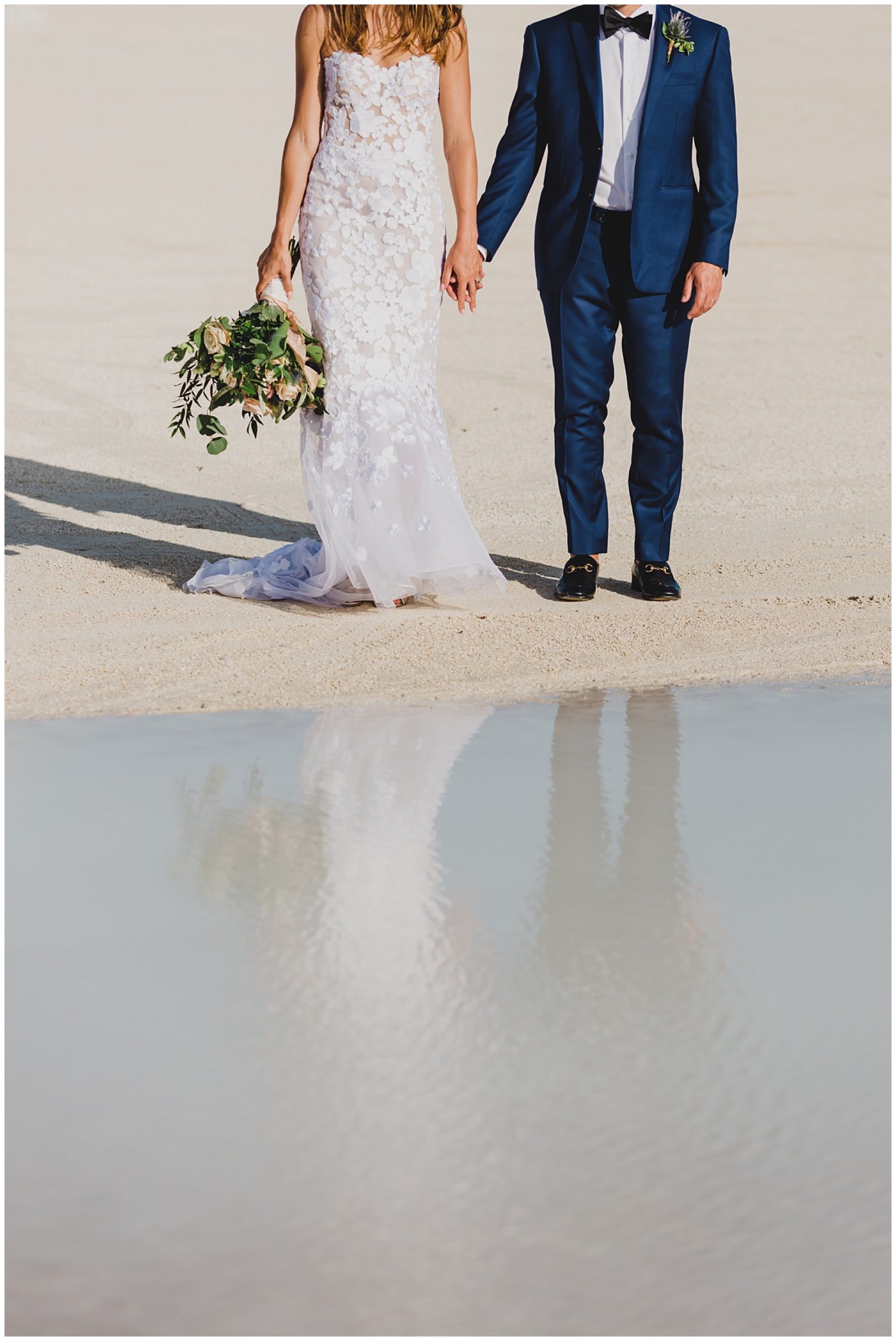 creative water reflection portrait of bride and groom at the beach